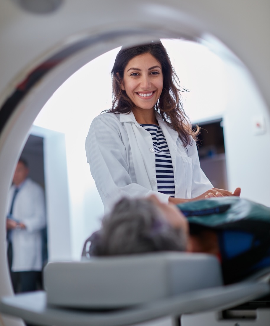 Portrait of doctor smiling as patient goes into MRI